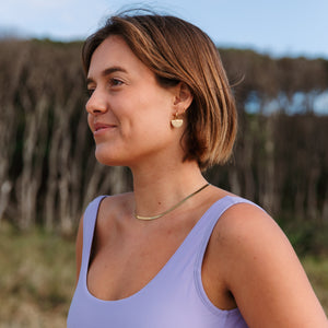 surfer girl wearing waterproof gold jewellery