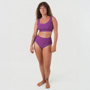 woman wearing surf bikini top and high-waist bikini bottoms in purple