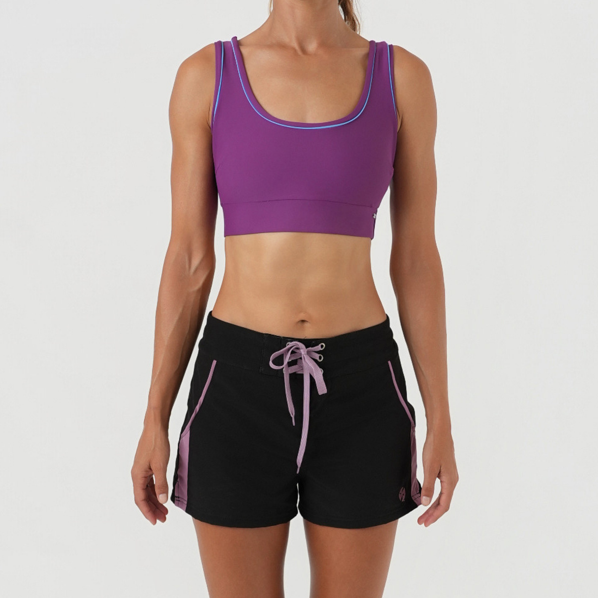 black boardshorts and purple bikini top