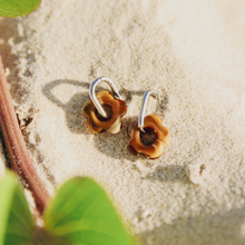 Pair of brown flower-shaped surf waterproof earrings silver hoops