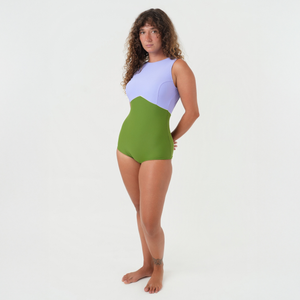 women wearing a two colorway surfsuit in green and purple