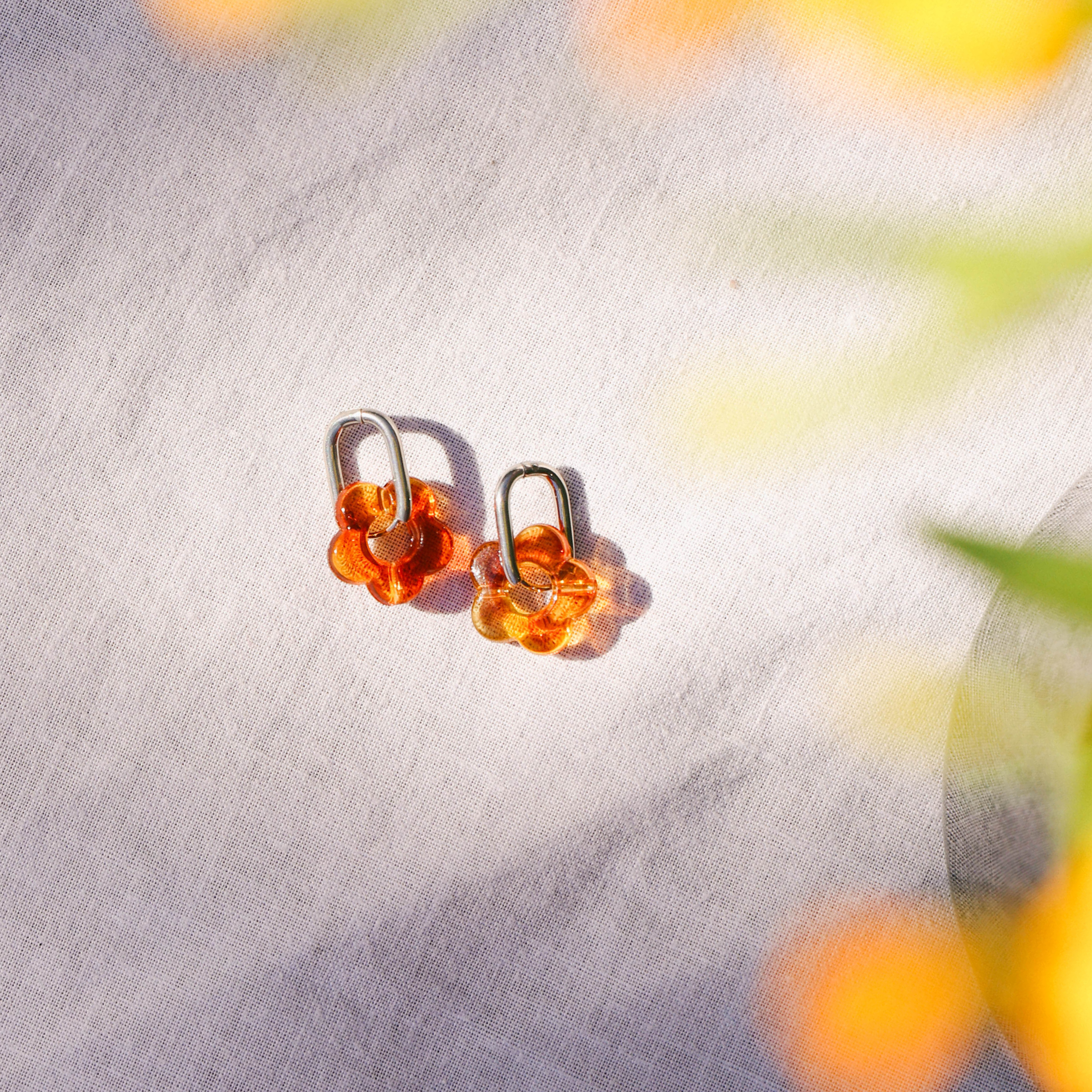 Pair of amber-colored earrings for surfing waterproof silver hoops
