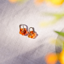 Pair of amber-colored earrings for surfing waterproof silver hoops