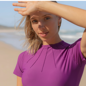 Woman wearing a purple top on a beach