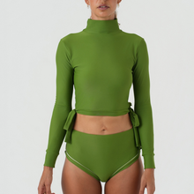 Green swimsuit with long sleeves and high-waisted bottoms 