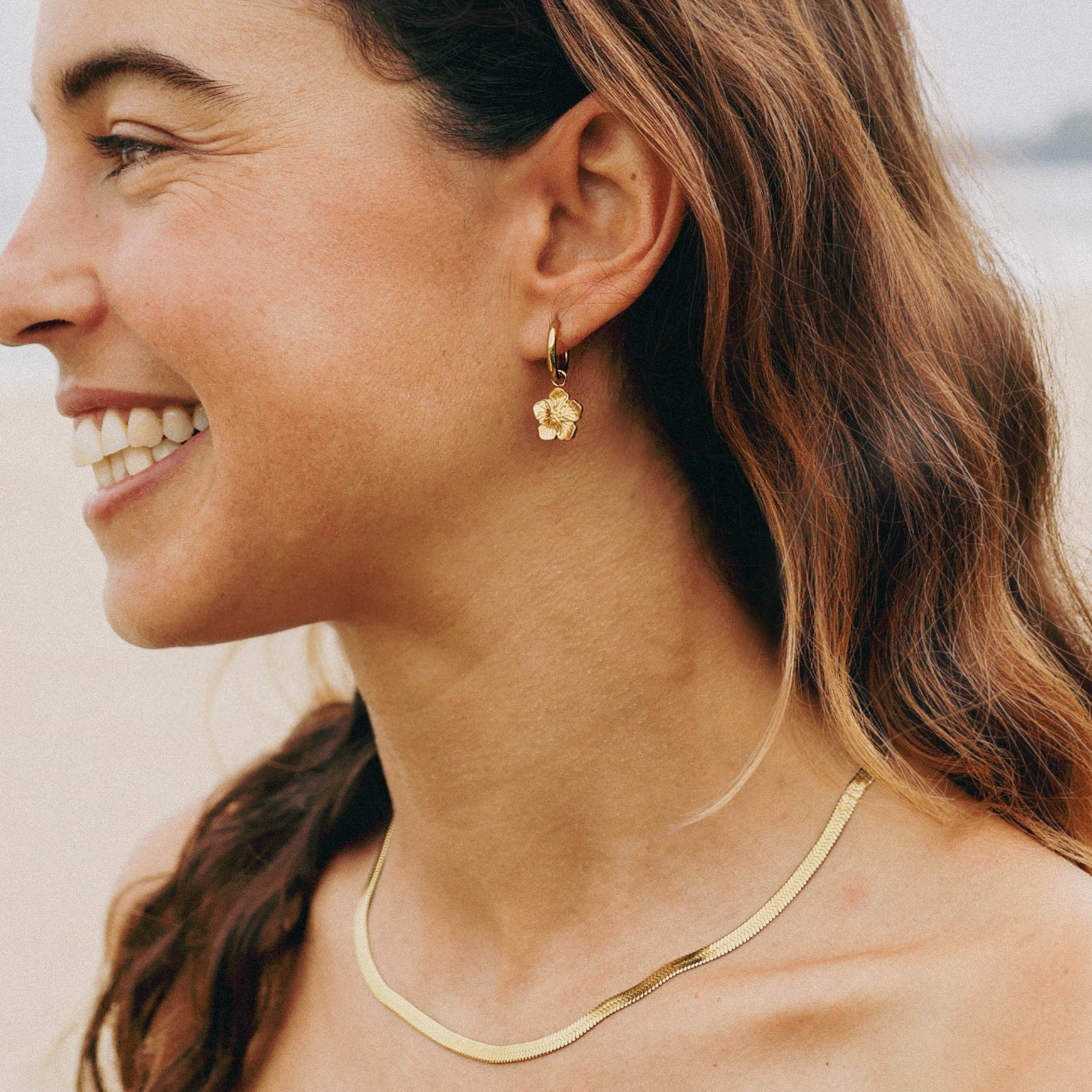 gold hibiscus flower earrings for surfing
