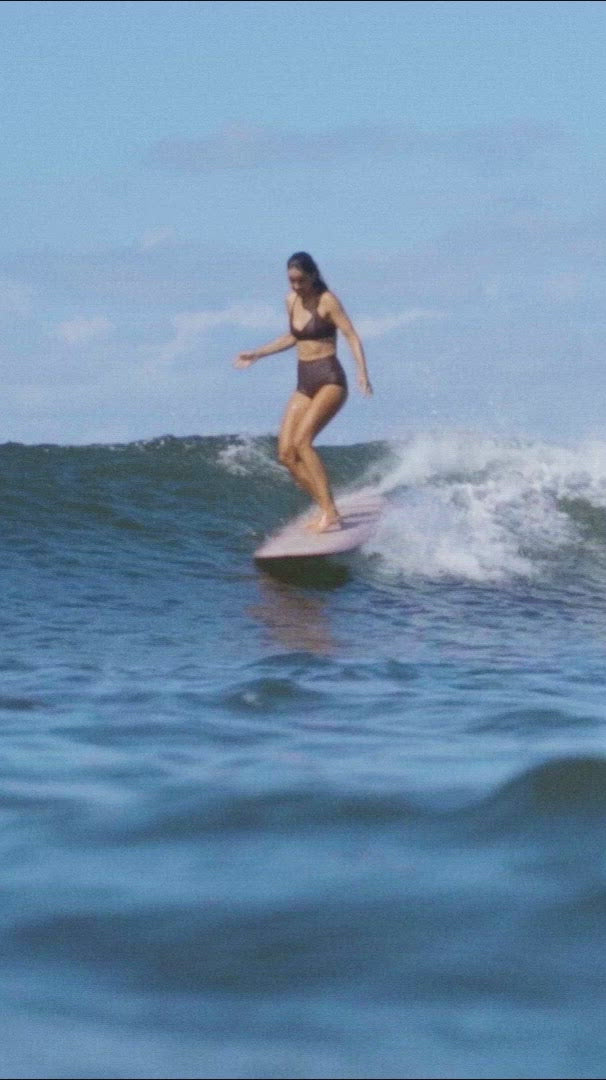 Surfer girl in brown bikini Lore of the Sea