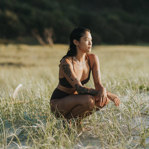 surfer girl wearing waterproof jewellery by Lore of the Sea