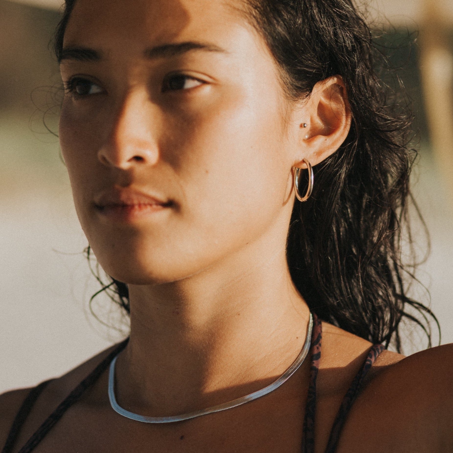 surfer girl wearing silver waterproof jewelry lore of the sea