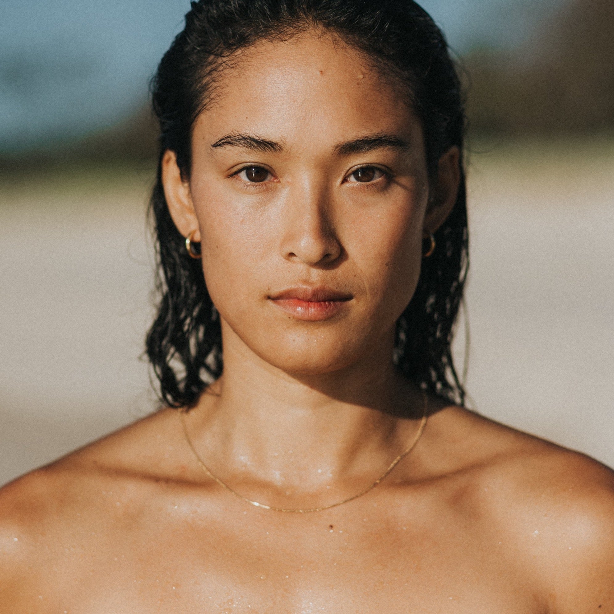 surfer girl wearing waterproof jewellery lore of the sea